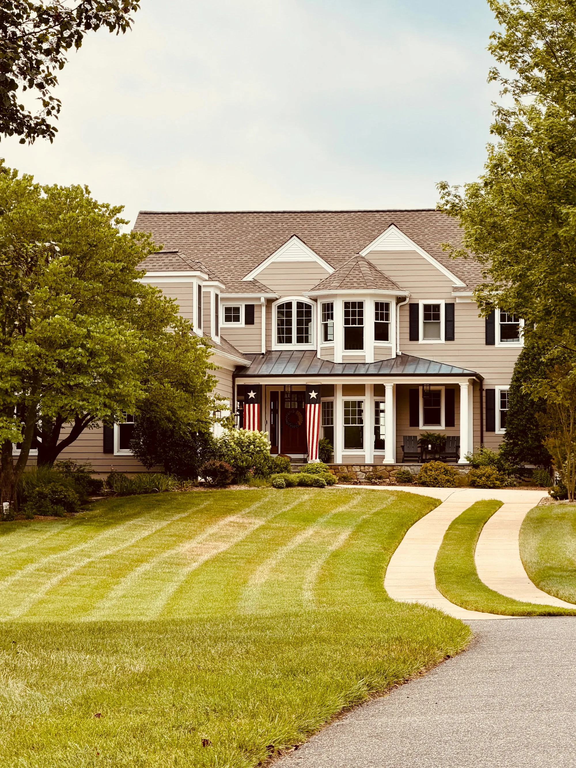 Large tan house with a curved front walk